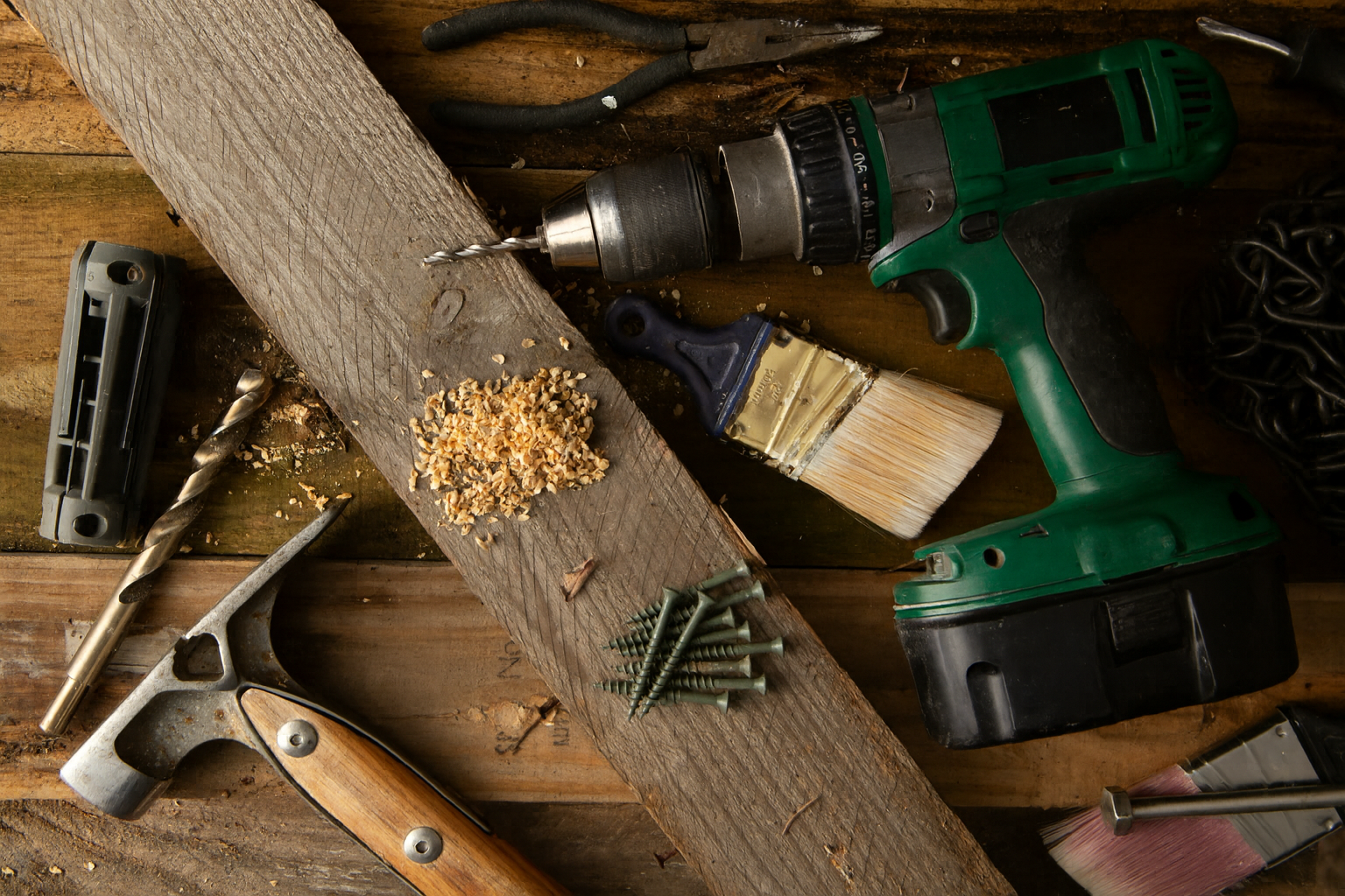 Professional woodworking tools and green power drill on wooden workbench - showcasing Brico's craftsmanship and attention to detail